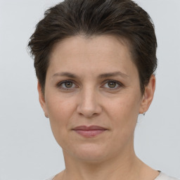 Joyful white adult female with short  brown hair and brown eyes