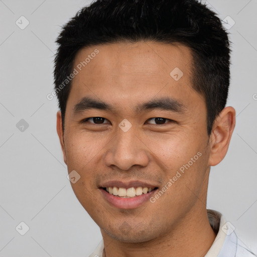 Joyful asian young-adult male with short  brown hair and brown eyes