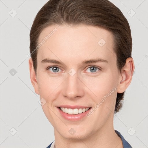 Joyful white young-adult female with short  brown hair and grey eyes