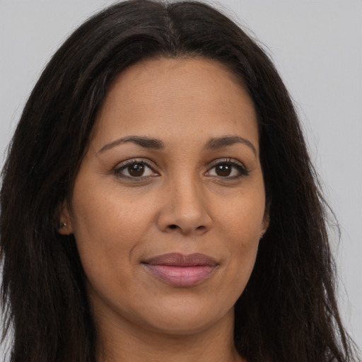 Joyful latino young-adult female with long  brown hair and brown eyes