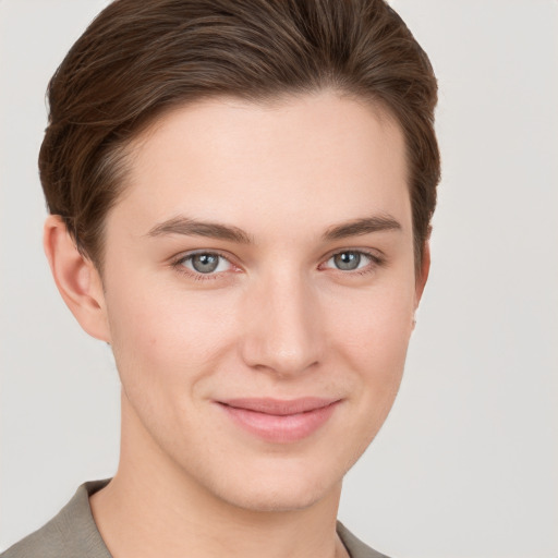 Joyful white young-adult female with short  brown hair and grey eyes