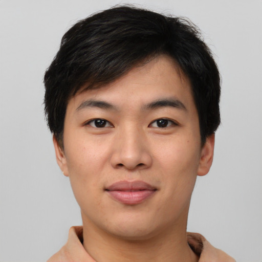 Joyful asian young-adult male with short  brown hair and brown eyes