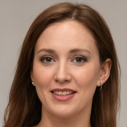 Joyful white adult female with long  brown hair and grey eyes