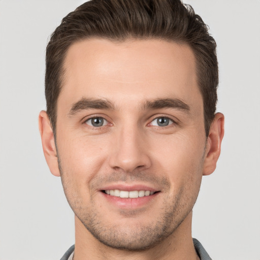 Joyful white young-adult male with short  brown hair and brown eyes