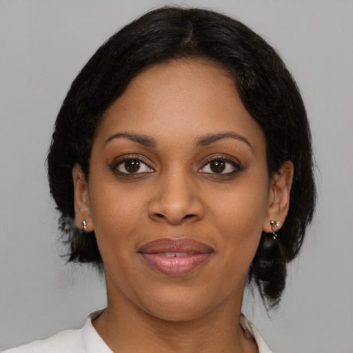 Joyful black young-adult female with medium  brown hair and brown eyes