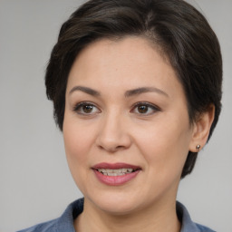 Joyful white adult female with medium  brown hair and brown eyes