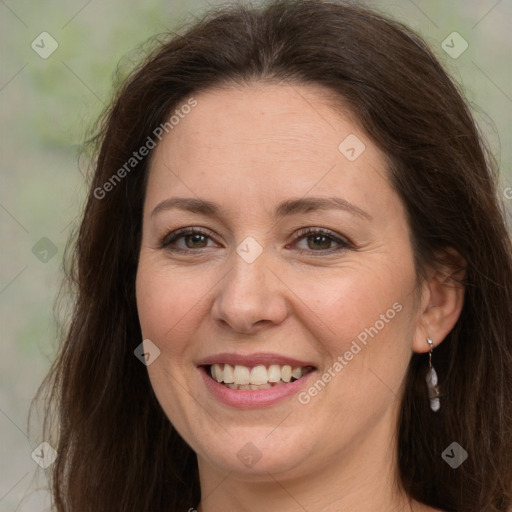 Joyful white adult female with long  brown hair and brown eyes