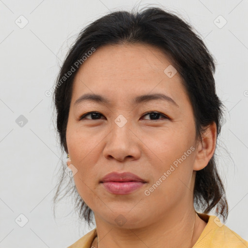 Joyful asian adult female with medium  brown hair and brown eyes