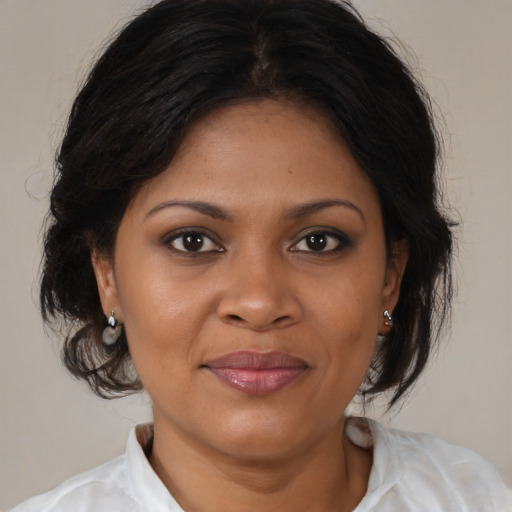 Joyful black young-adult female with medium  brown hair and brown eyes