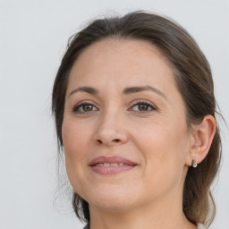 Joyful white adult female with long  brown hair and brown eyes