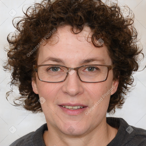 Joyful white adult female with medium  brown hair and blue eyes