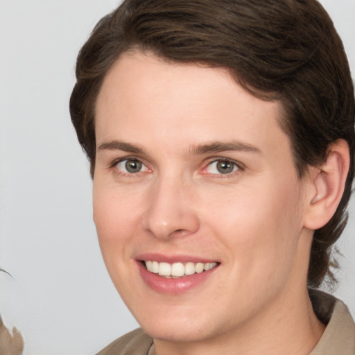 Joyful white young-adult female with medium  brown hair and grey eyes