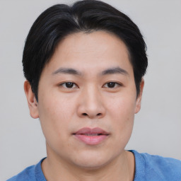 Joyful asian young-adult male with short  brown hair and brown eyes