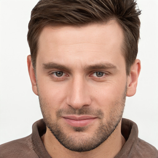 Joyful white young-adult male with short  brown hair and grey eyes