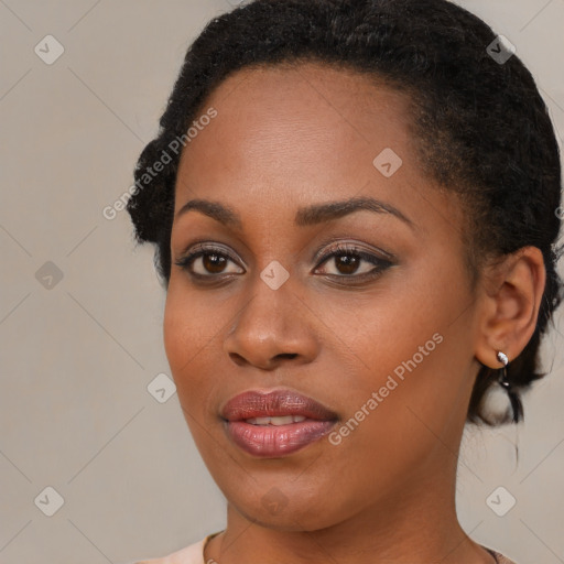 Joyful black young-adult female with medium  brown hair and brown eyes