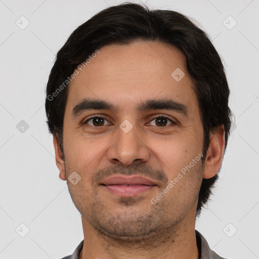 Joyful white young-adult male with short  black hair and brown eyes