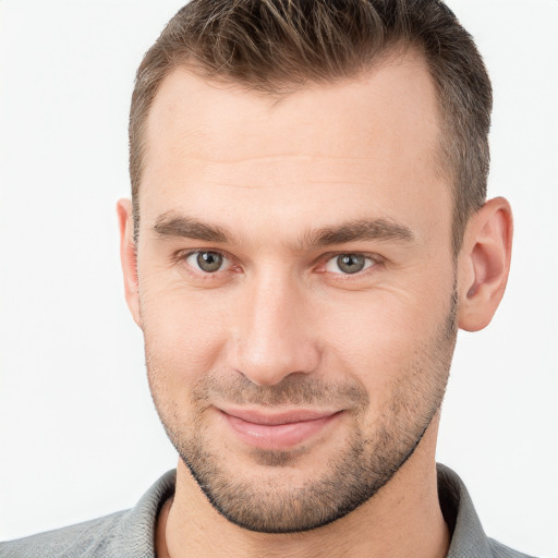 Joyful white young-adult male with short  brown hair and brown eyes