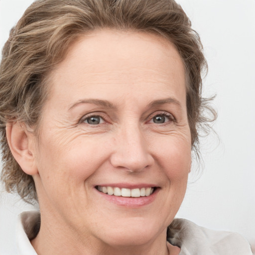 Joyful white adult female with medium  brown hair and grey eyes