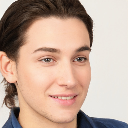 Joyful white young-adult male with medium  brown hair and brown eyes