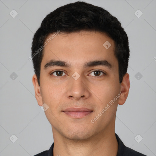 Joyful white young-adult male with short  black hair and brown eyes