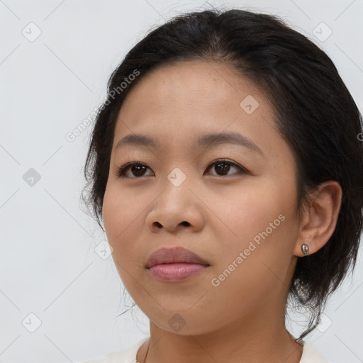 Joyful asian young-adult female with medium  brown hair and brown eyes