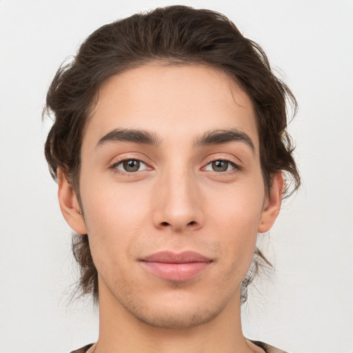 Joyful white young-adult male with medium  brown hair and brown eyes