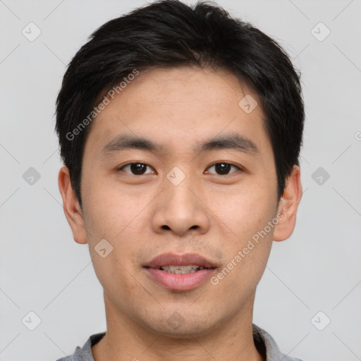 Joyful asian young-adult male with short  black hair and brown eyes