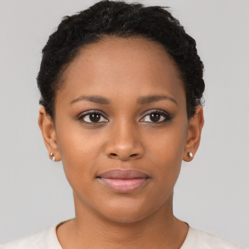 Joyful black young-adult female with short  brown hair and brown eyes
