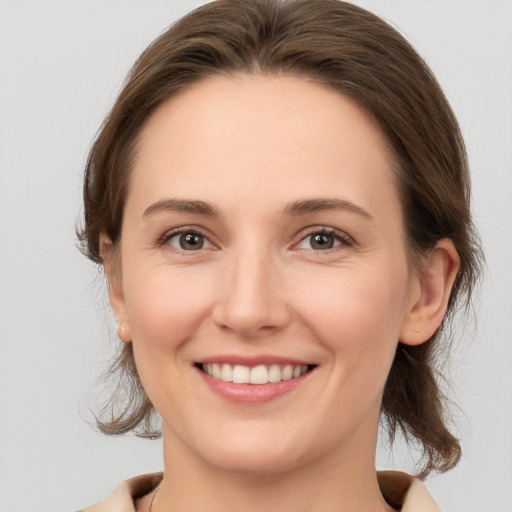 Joyful white young-adult female with medium  brown hair and brown eyes