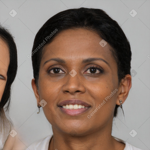 Joyful black young-adult female with medium  black hair and brown eyes