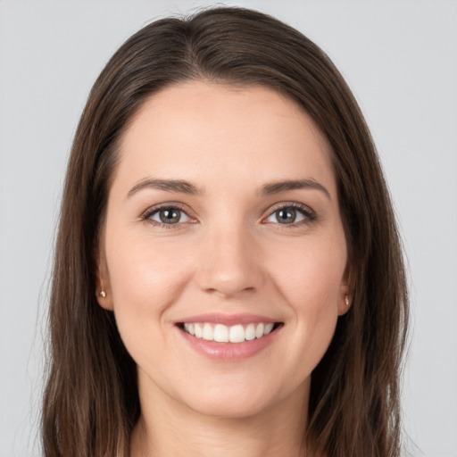 Joyful white young-adult female with long  brown hair and grey eyes