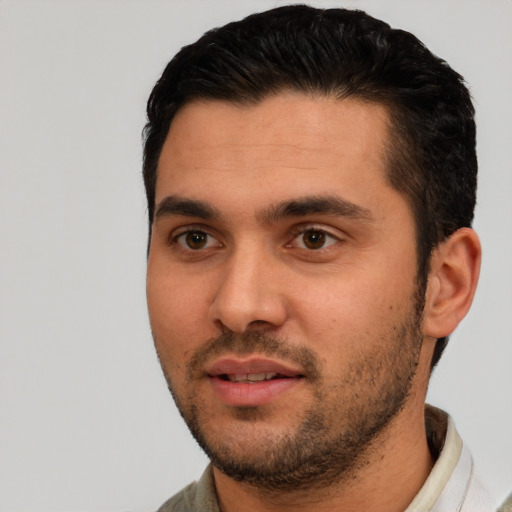 Joyful white young-adult male with short  black hair and brown eyes