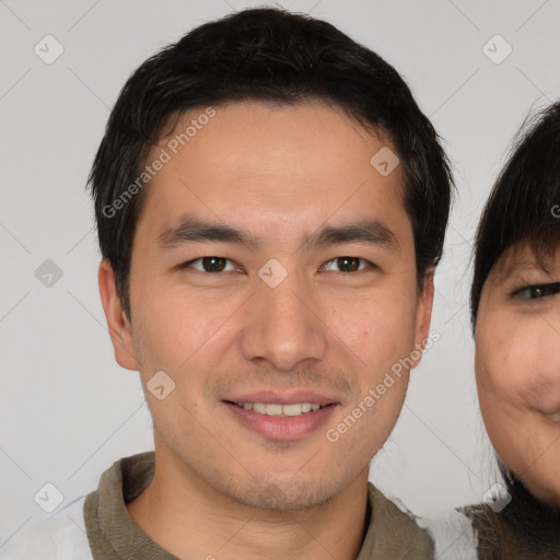 Joyful asian young-adult male with short  brown hair and brown eyes