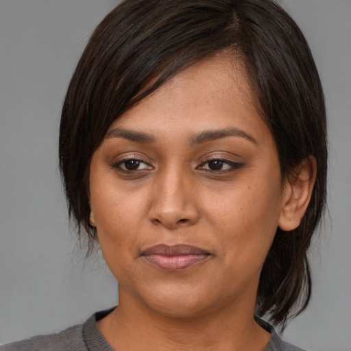 Joyful asian young-adult female with medium  brown hair and brown eyes