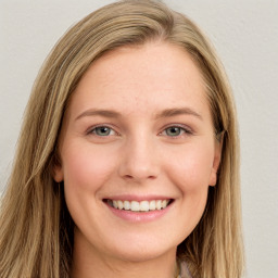 Joyful white young-adult female with long  brown hair and green eyes