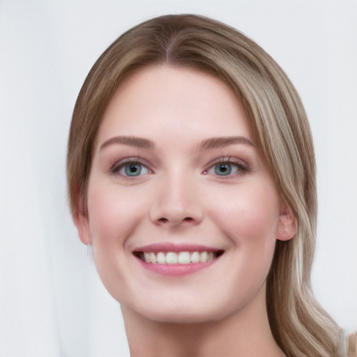 Joyful white young-adult female with long  brown hair and blue eyes