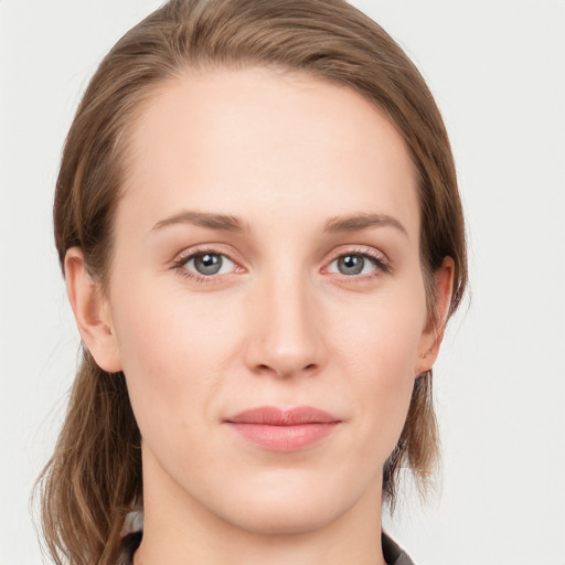 Joyful white young-adult female with medium  brown hair and blue eyes