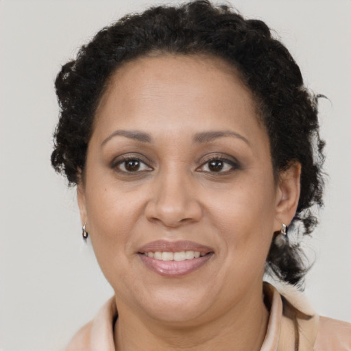 Joyful latino adult female with medium  brown hair and brown eyes