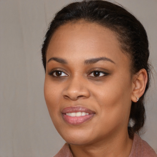 Joyful black young-adult female with medium  brown hair and brown eyes