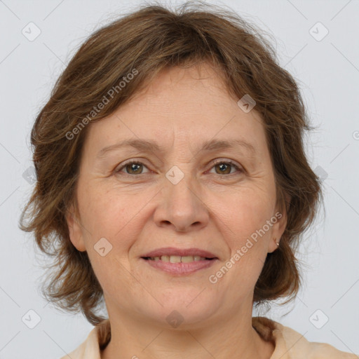 Joyful white adult female with medium  brown hair and grey eyes