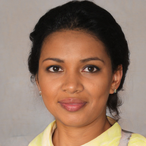 Joyful black young-adult female with medium  black hair and brown eyes