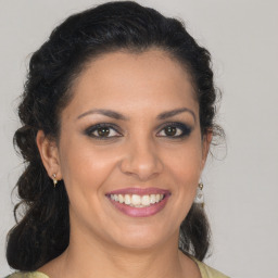 Joyful latino young-adult female with medium  brown hair and brown eyes