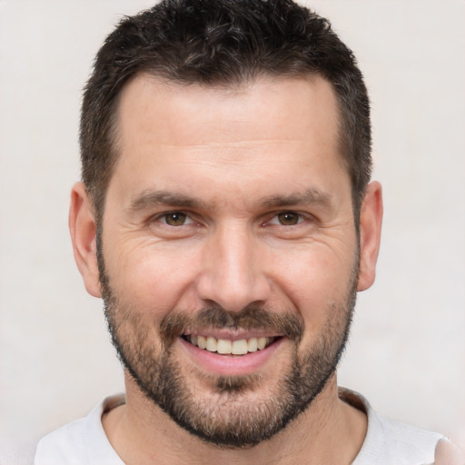 Joyful white adult male with short  brown hair and brown eyes