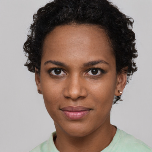 Joyful black young-adult female with short  brown hair and brown eyes
