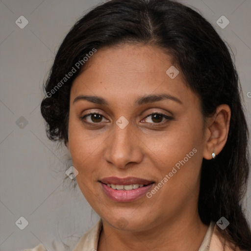 Joyful latino adult female with medium  brown hair and brown eyes