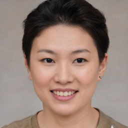 Joyful asian young-adult female with short  brown hair and brown eyes