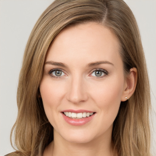 Joyful white young-adult female with long  brown hair and green eyes