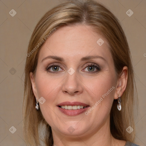 Joyful white adult female with medium  brown hair and blue eyes