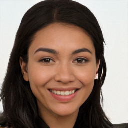 Joyful latino young-adult female with long  brown hair and brown eyes