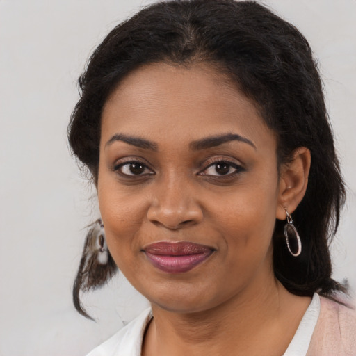 Joyful black young-adult female with medium  brown hair and brown eyes
